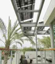 Residential Solar Panel Awning covers the outdoor seating area while providing solar power, shade and protection from the weather.