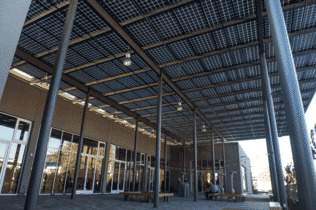 Solar Canopy with glass-glass solar panels covers the entryway at the Pastoria Building in California.