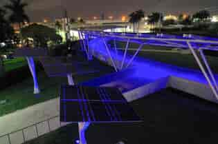 LSX Curved SolarScape lit in colored lights with solar trees in the foreground from an aerial view of Miami Bayfront Park at Night