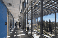 Solarscape Solar Panel Awning is seen through the windows as students walk through the hallway at UC Irvine