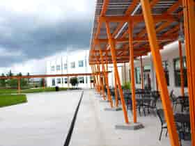 Custom LSX Solar Canopies providing shaded seating area and walkway at K-12 school with solar energy for outside eating and recreating.